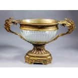 A late 19th Century French gilt metal and cut glass oval two-handled urn of "Louis XVI" design, with