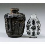 A Chinese horn snuff bottle deeply carved with figures in a garden