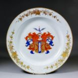 A Chinese Dutch Market porcelain circular charger, the centre enamelled with an armorial crest,