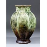 An early 20th Century Martinware stoneware vase of panelled baluster shape, each panel with a raised