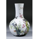 A Chinese porcelain Famille Rose bottle vase enamelled with magpies amongst prunus branches, 5ins (