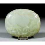 A Chinese jade oval plaque carved in relief with two peaches and two deer, 5.25ins (13.3cm) x 4.