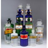 A collection of thirty-one clear and coloured glass chemists jars and stoppers, mostly with