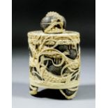 A Japanese carved and stained ivory cylindrical box and cover, the whole carved in relief with quail