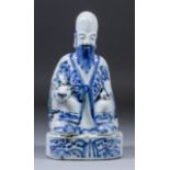 A Chinese blue and white porcelain figure of Shou Lao, the God seated atop a recumbent deer and