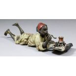 A late 19th/early 20th Century Austrian cold painted bronze figure of a boy making coffee, 2ins