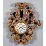 A late 19th Century French carved walnut cased wall clock, the 5.25ins diameter dial with Roman