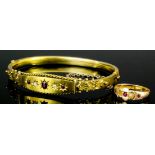 A late Victorian 14ct gold ruby and diamond set stiff pattern bangle, the central panel set with