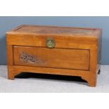 A Chinese panelled hardwood rectangular blanket chest, the top and front panel carved with