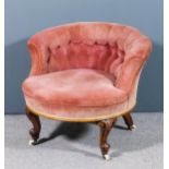 A Victorian lady's walnut low tub-shaped easy chair upholstered in rose dralon, the back buttoned,