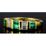 A modern gold coloured metal mounted emerald and diamond set half hoop eternity ring, the face set