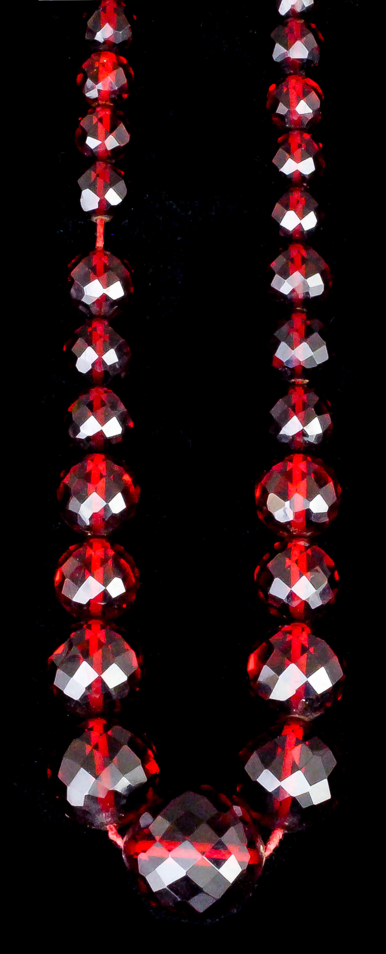 A late Victorian single strand of graduated faceted red amber beads, the eighty nine beads ranging