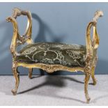 A late 19th Century French gilt window seat of "Louis XV" design, with shaped and moulded frame