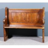 A Victorian pine pew of small proportions, with panelled back and shaped end supports, 40ins wide