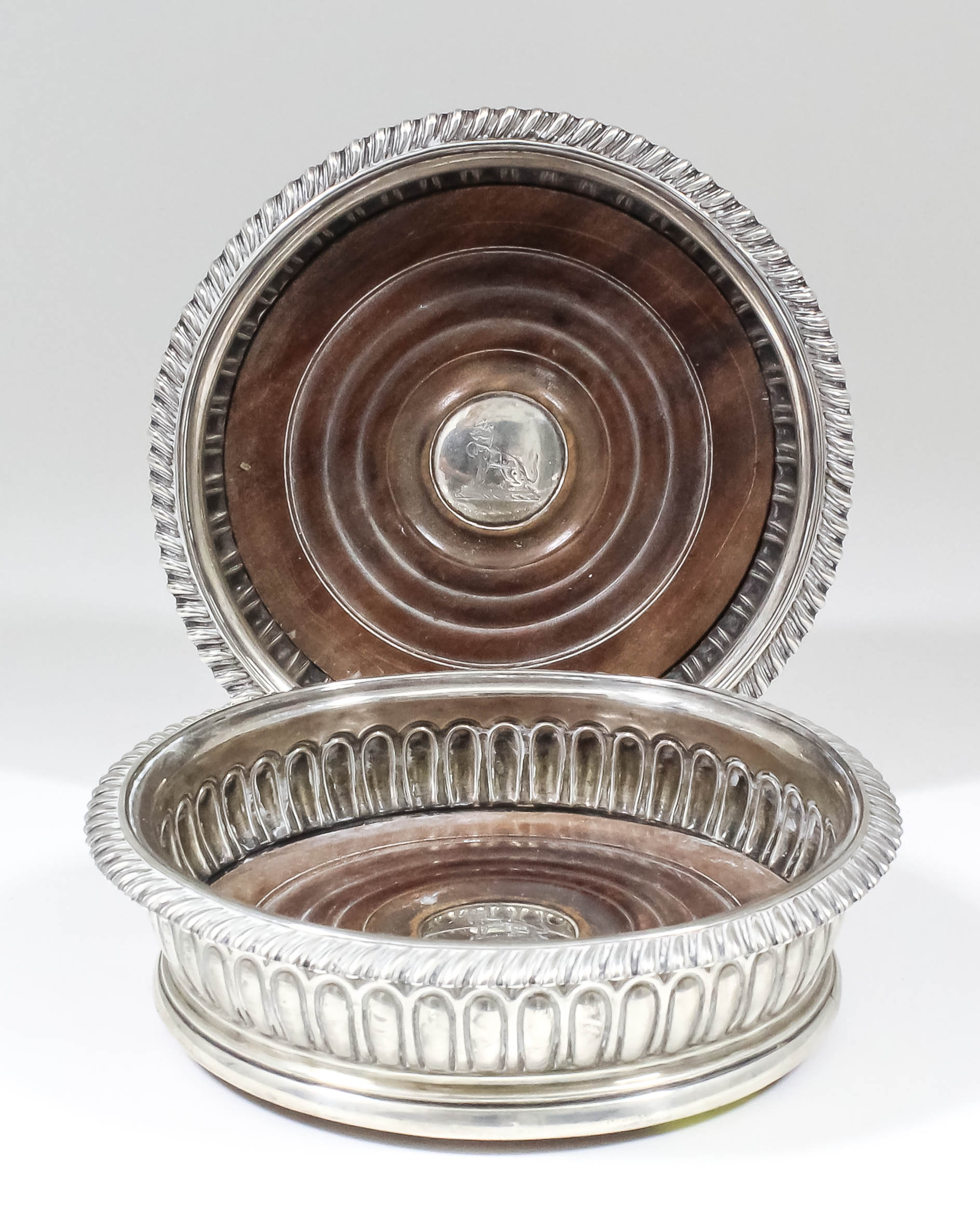 A pair of late George III silver circular coasters with gadroon mounts and part reeded bodies,