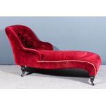 A late Victorian chaise lounge with spoon shaped end, upholstered in deep wine dralon, the end