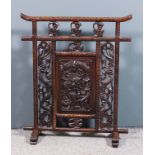 A Chinese hardwood rectangular fire screen inset with central panel carved with a dragon and with