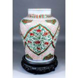 A Chinese porcelain "Famille Verte" baluster-shaped vase painted in reds, greens and yellows with