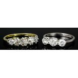 A modern 18ct white gold mounted three stone diamond ring, the central brilliant cut stone of