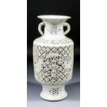 A Chinese Blanc de Chine reticulated two-handled vase, the body carved with mythological birds, 12.