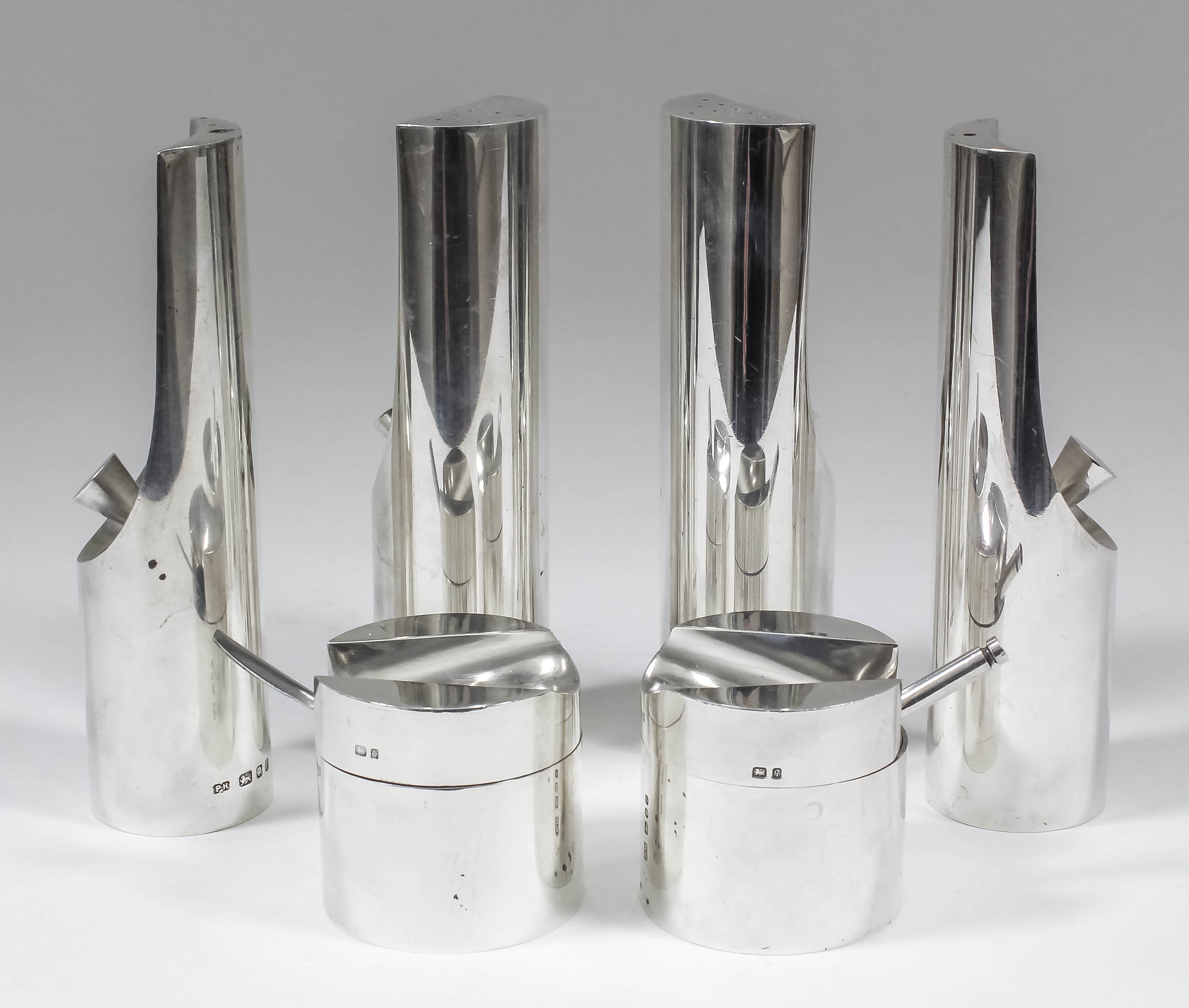 An Elizabeth II plain silver cylindrical six piece condiment set by Paul Harrison, London 1971,