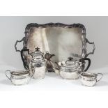 A George V silver rectangular four piece tea service with moulded rim, the bodies engraved with leaf