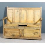 A 19th Century panelled stripped pine settle with five panel rectangular back and box seat, on