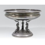 An early 20th Century French silver circular bowl with moulded rim, on three dolphin pattern