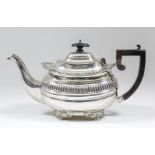 An Edward VII silver rectangular teapot with gadroon and shell mounts, part reeded body above