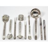 An Elizabeth II silver table service (for six place settings), with textured rectangular handles,