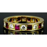 A modern gold coloured metal mounted ruby and diamond full hoop eternity ring, the face set with ten