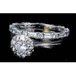 A modern 18ct white gold mounted all diamond set flower head pattern ring, the face set with nine