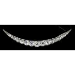 A Victorian silvery coloured metal mounted all diamond set crescent pattern brooch, the face set