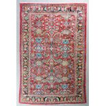 A Mahal carpet woven in colours with shaped geometric motifs, leaves and floral ornament, on a