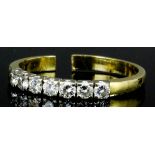 A modern 14ct white and yellow gold mounted diamond set half hoop eternity ring, the face set with