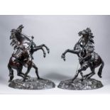 A pair of late 19th French brown patinated bronze figures of Mali horses after Guillaume Coustou (