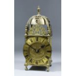 An early 20th Century brass cased lantern clock with 5.25ins diameter chapter ring with Roman
