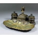 A late 19th Century French bronze inkstand with shell pattern dish to front, the central lidded