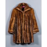 A lady's dark brown mink jacket with three-quarter length sleeves, lined, size 12-14, 32ins long