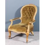 A Victorian walnut framed spoon back open arm easy chair, the moulded showwood frame with scroll