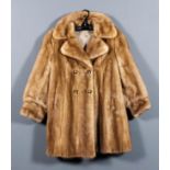 A lady's blonde mink double breasted jacket with cuffed sleeves, lined, size 10-12, 34ins long