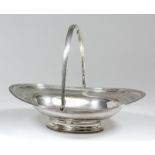 A George III silver oval cake basket with reeded mounts and folding bale handle, engraved with a