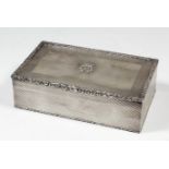 A George VI silver rectangular cigarette case with floral and leaf scroll mounts, the lid with