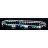 A modern silvery coloured metal mounted sapphire, diamond, and emerald tennis bracelet, the face set