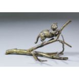 A late 19th Century Continental bronze model of a cat on a branch, 3.25ins high, IMPRESSED...