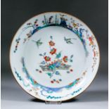 A Chinese porcelain circular dish enamelled in the "Kakiemon" palette, with floral spray and birds