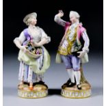 A pair of late 19th Century Meissen porcelain figures modelled as two companions in 18th Century