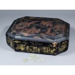 A Chinese black lacquer octagonal games box painted in red and decorated in gilt with figures in a