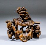 A Japanese carved boxwood okimono of a demon on the roof of a palanquin with the occupant falling