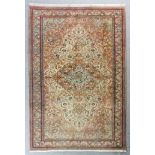 An Anatolian carpet woven in pastel shades with a floral filled central lozenge-shaped medallion and